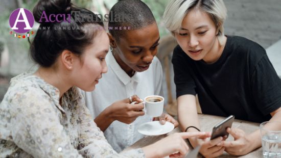 A multicultural group of three girls looking at social media on a phone